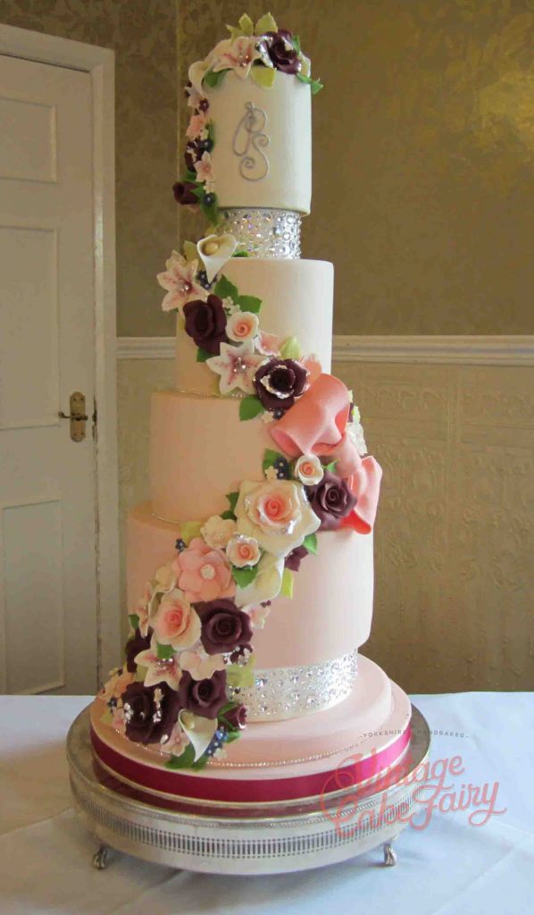 Tall 4 tier wedding cake with sugar bow, sugar flowers and swarovski crystals 