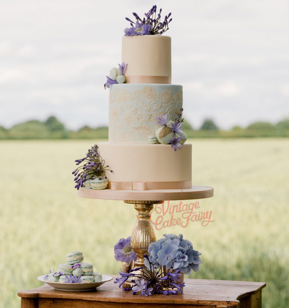 Wedding cake with macarons, cake lace and fresh flowers